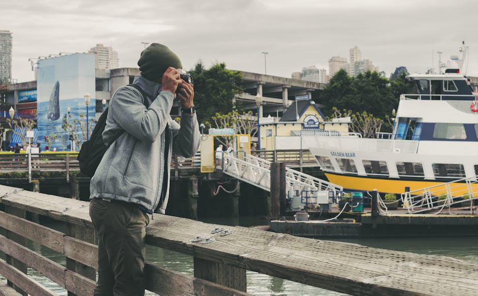 A photographer captures the San Francisco waterfront with a docked ferry in the backdrop.