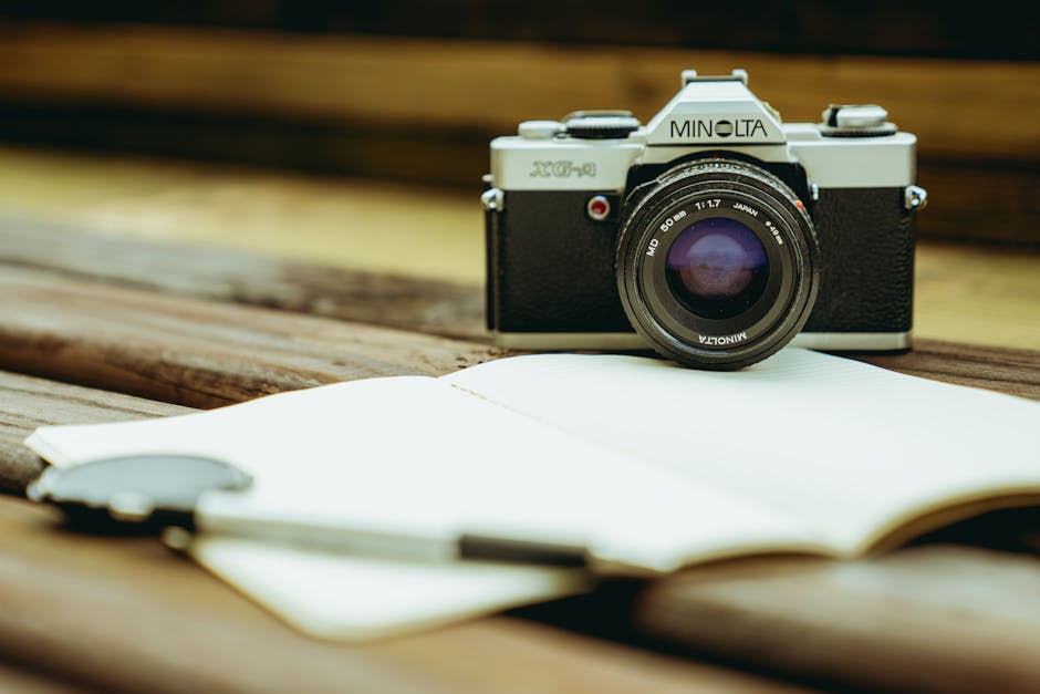 Classic Minolta film camera with a vintage lens on a wooden table, capturing a nostalgic feel.